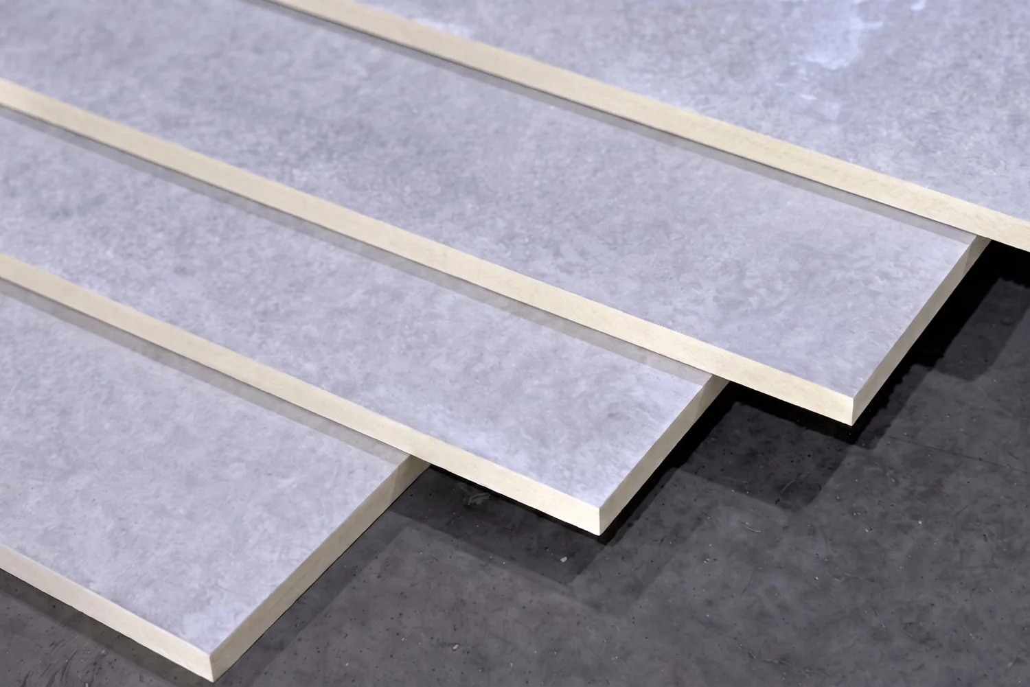 Fiber cement wall boards fanned to show faces and edges